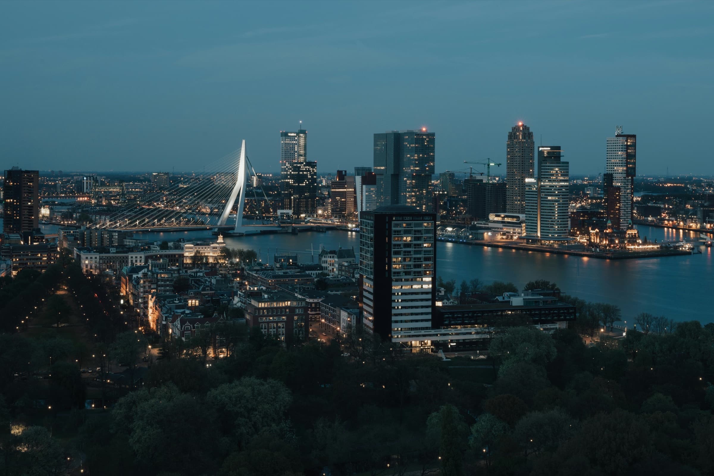 The Rotterdam skyline at dusk, with the Erasmusbrug over the river Maas